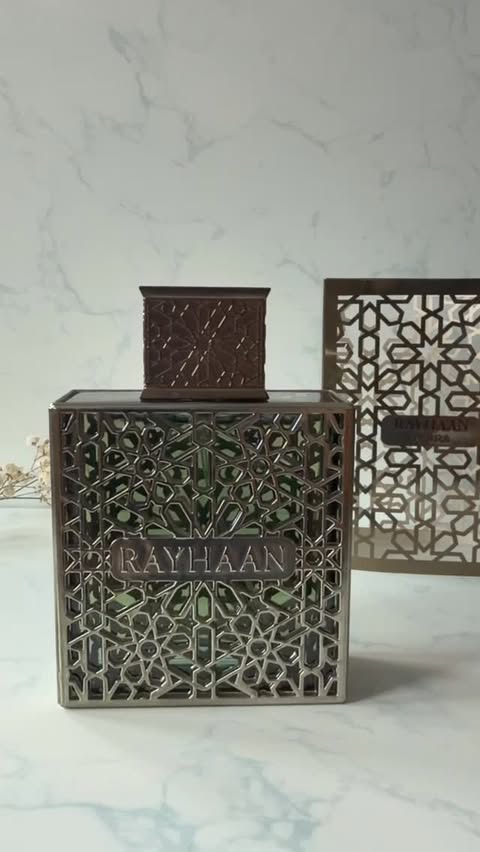 Instagram post by @glambyghiz for Rayhaan Perfumes. Caption reads: Earthy. Warm. Timeless. A refined blend crafted....