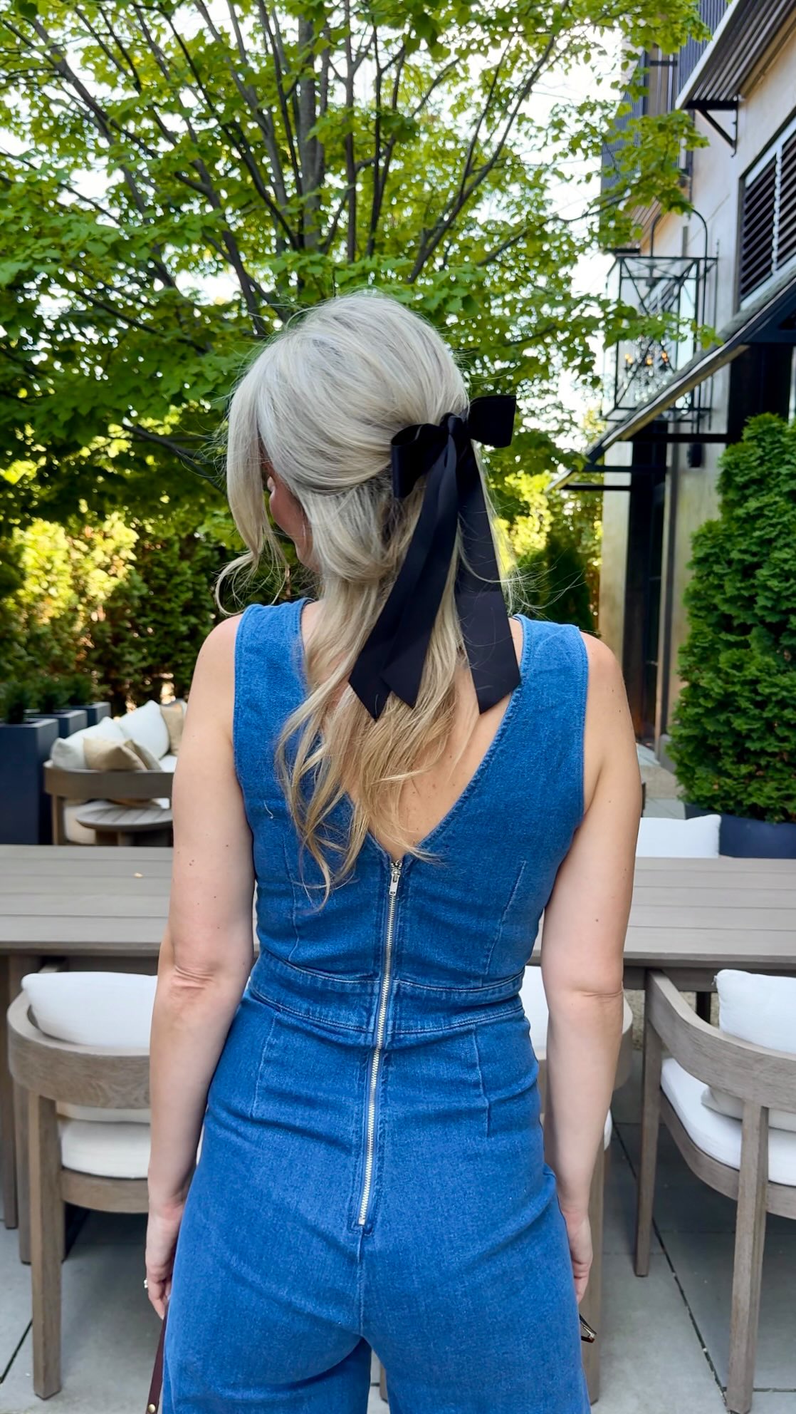 Instagram post by @minjamusich for Unique Vintage. Caption reads: Just a mom in a denim jumpsuit, living her best....