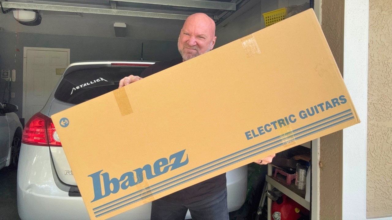 YouTube post by @jasonstallworth for Sweetwater Integration. Caption reads: Unboxing 7 String Metal Guitar (Ibanez Prestige....
