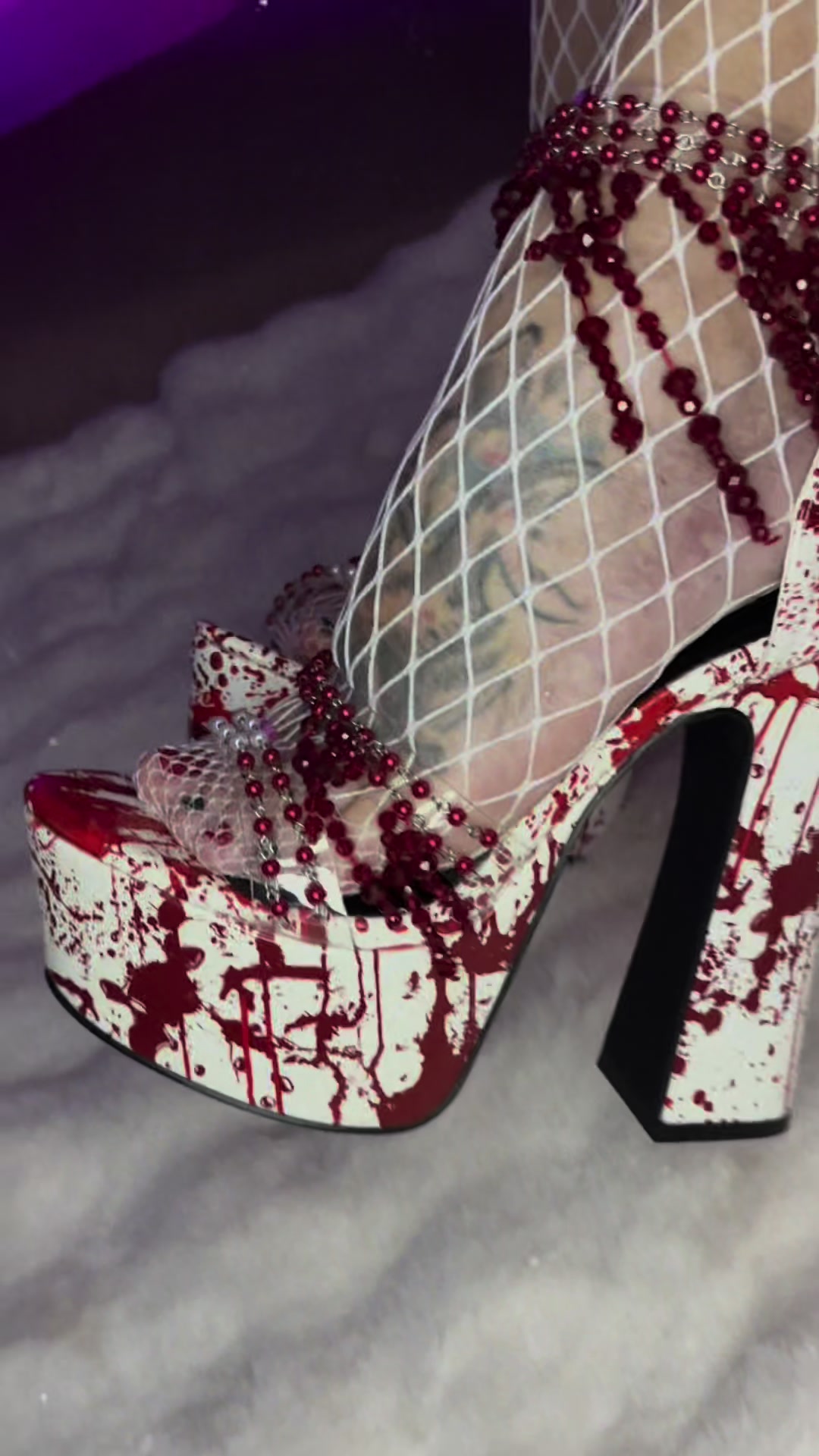 TikTok post by @bangbangpineapplegangpod for Dolls Kill. Caption reads: [...] heels. #bloodspatter #heels #highheels....