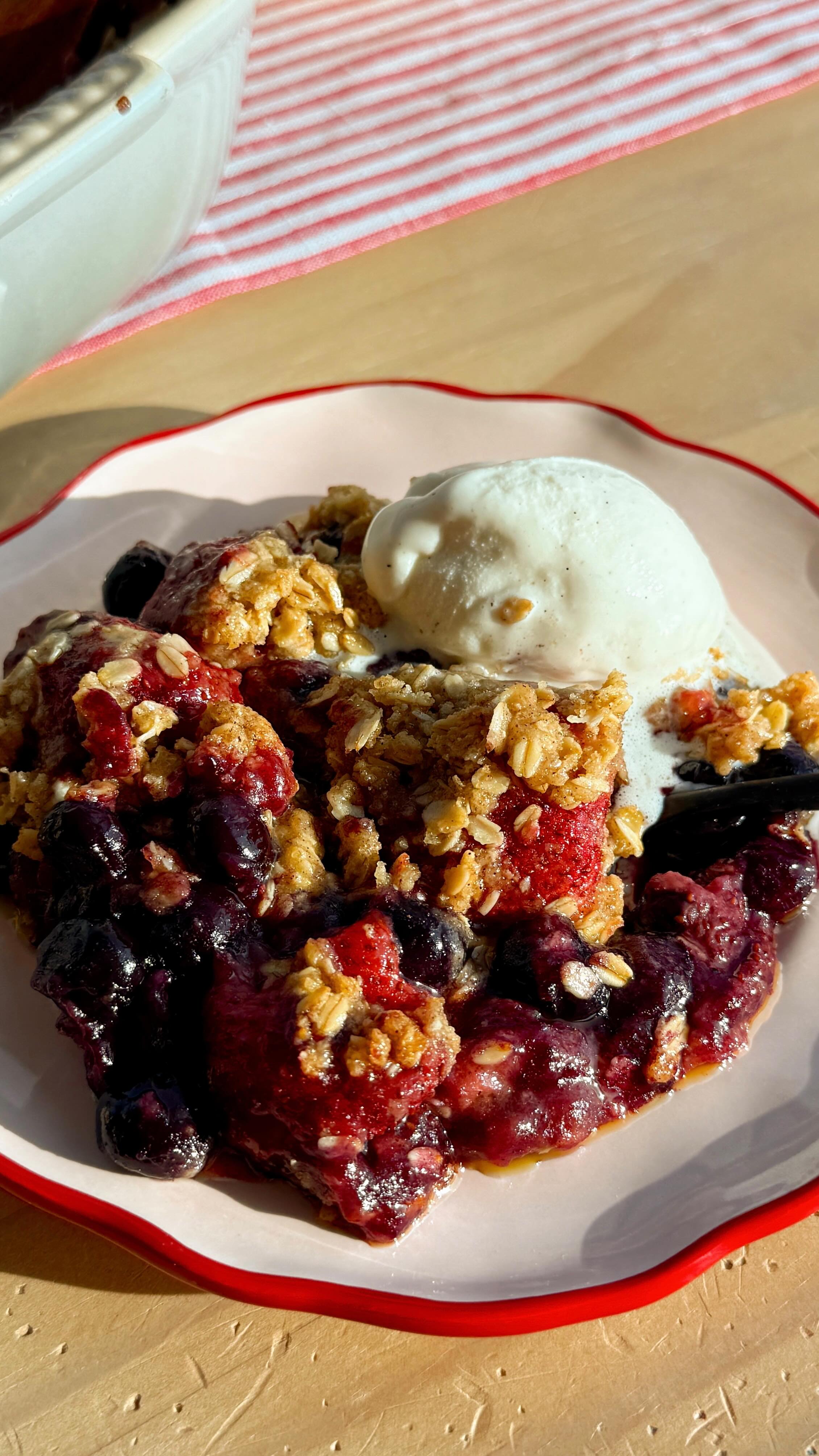 Instagram post by @munchinwithmaddie_ for Pitaya Foods. Caption reads: a quintessential summer dessert…the berry crisp....