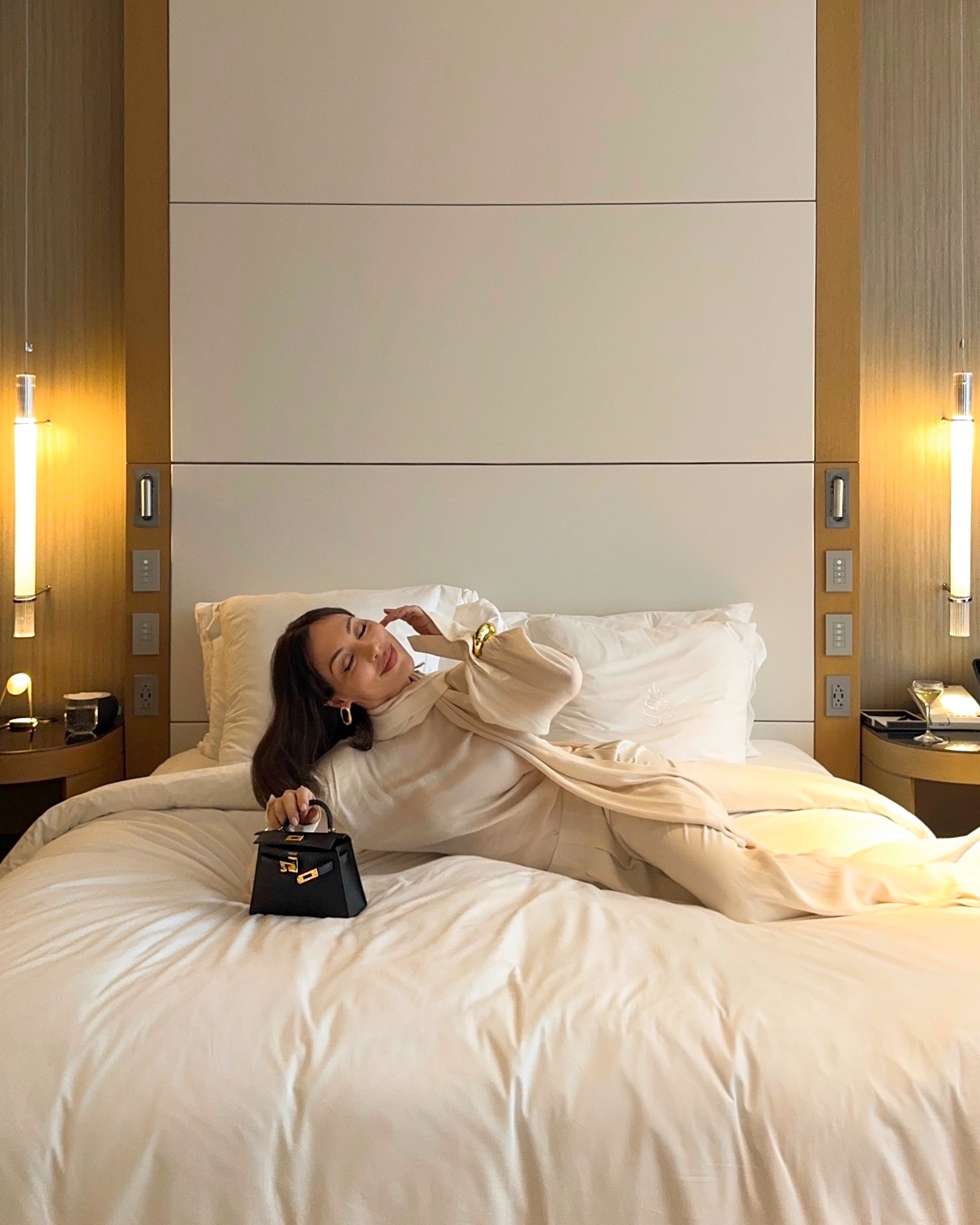 Instagram post by @aminavassa for Guerlain. Caption reads: High above the city, letting the evening unfold....