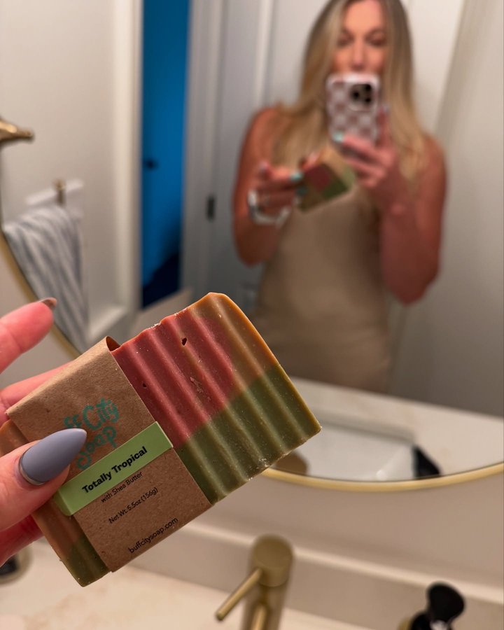 Instagram post by @gena_hartwick for Buff City Soap. Caption reads: [...] Of: Lemon, Pomegranate, & Cream....
