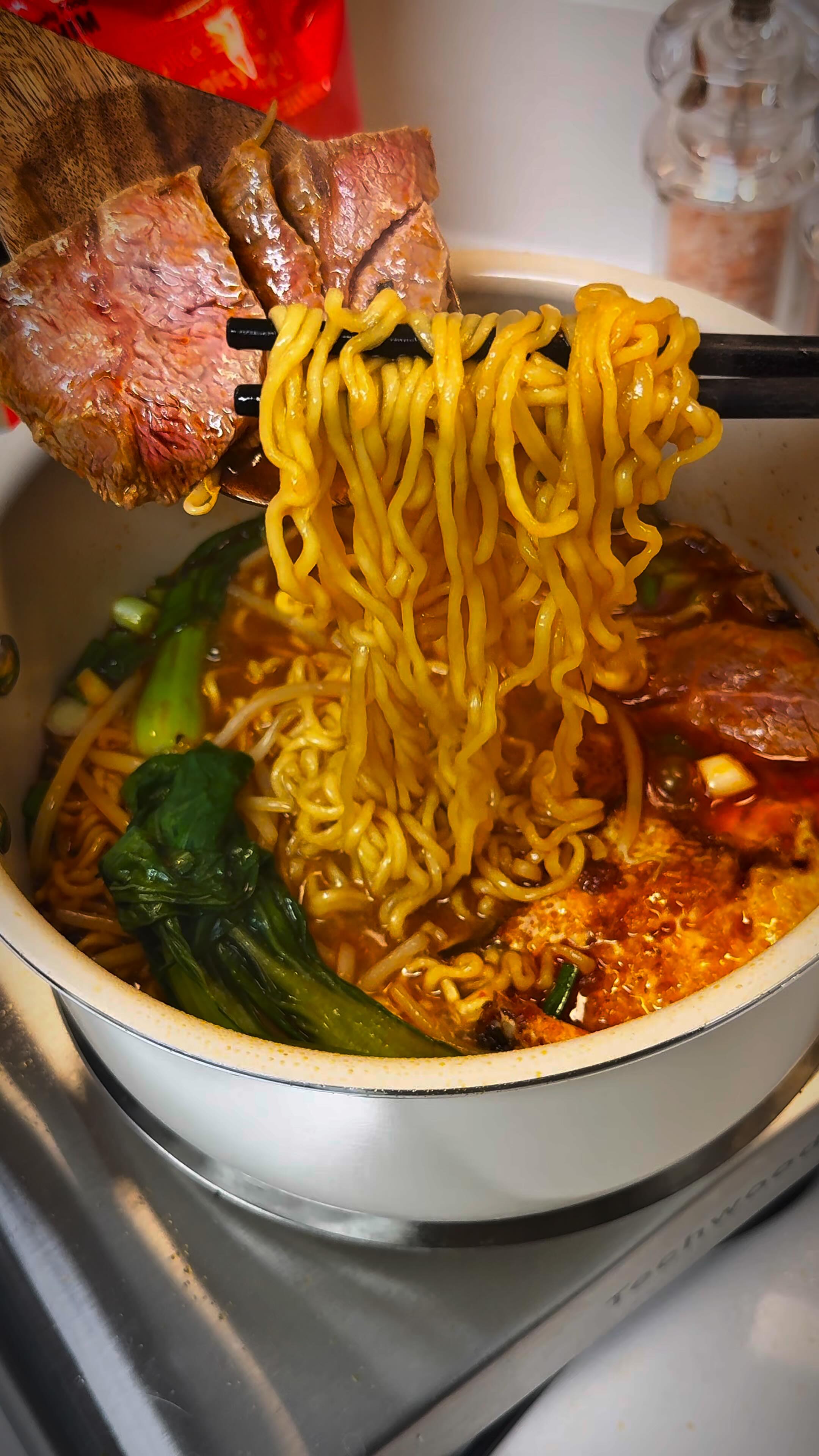 Instagram post by @haileyateit for Nongshim USA. Caption reads: Hangover🫠? A spoon of chili oil makes everything....