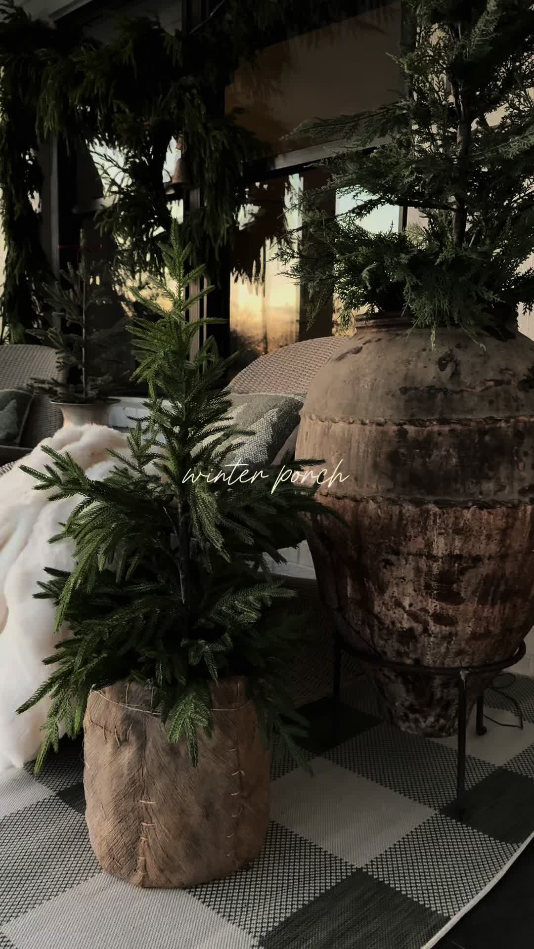 TikTok post by @kristinanevans for Boutique Rugs. Caption reads: Winter porch is complete! You can find the 🔗 on....