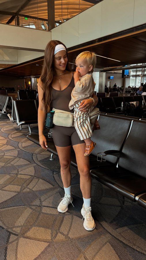 Instagram post by @jamienkidd for Tushbaby. Caption reads: Traveling with a toddler made way easier with....