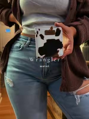 TikTok post by @katiegraff2 for Vaqueras Outfitters. Caption reads: 🤎🤎 @Vaqueras Outfitters #purse #wallet....
