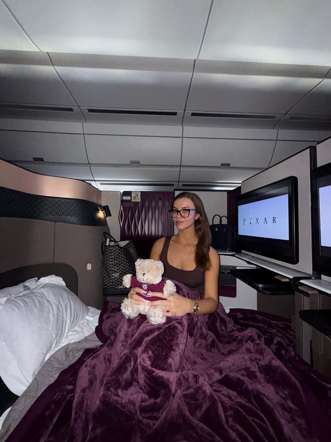 Instagram post by @isobellorna_ for Qatar Airways. Caption reads: Around the world in the Q suite 🥹✈️*what shall we....