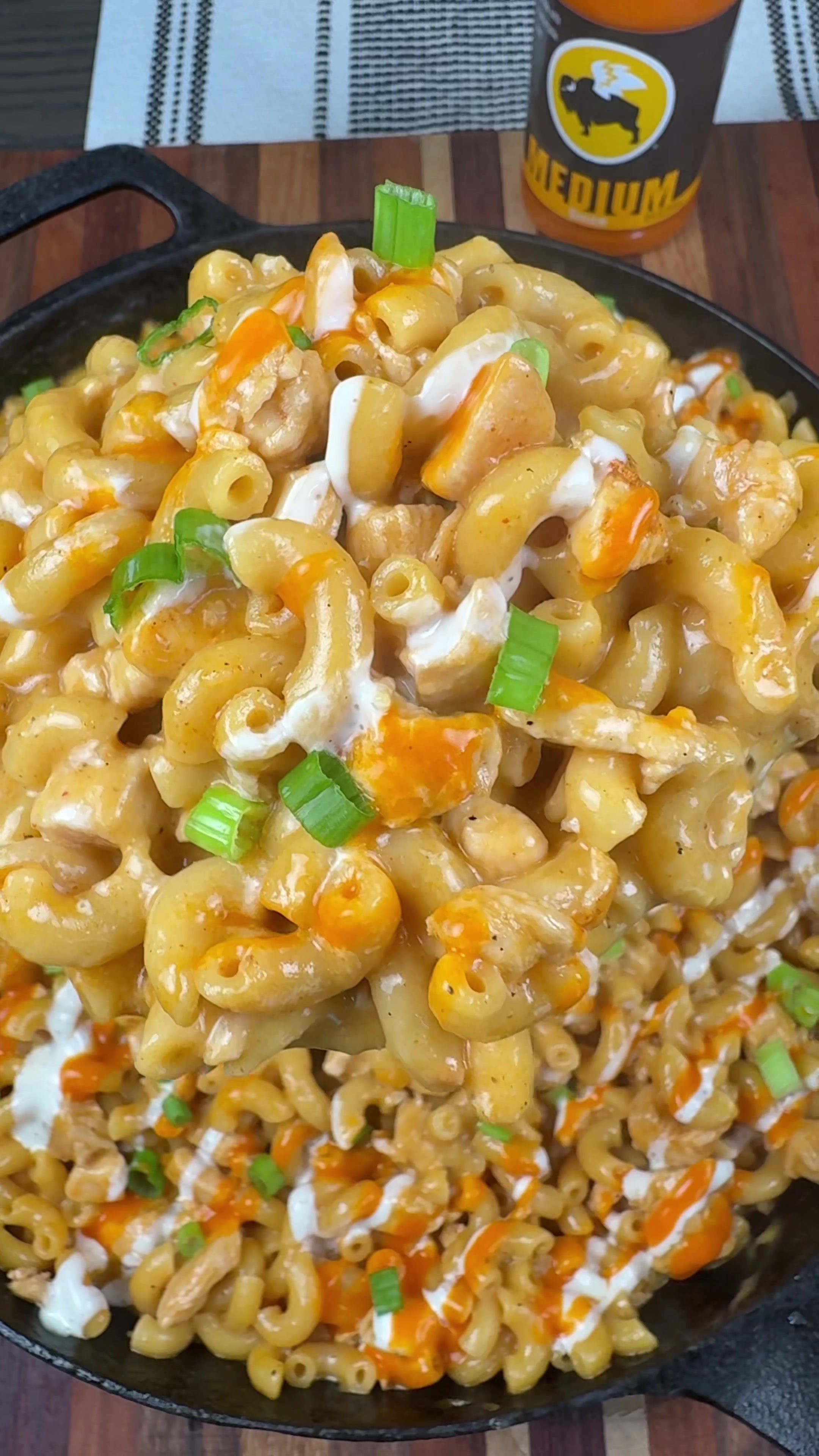 TikTok post by @cookinginthemidwest for Buffalo Wild Wings. Caption reads: #sponsored Cheesy Buffalo Chicken Mac is an easy....
