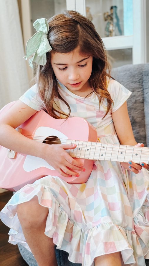 Instagram post by @waterwings.finger for Loog Guitars. Caption reads: Perfect kid sized guitars from @loogguitars Since....