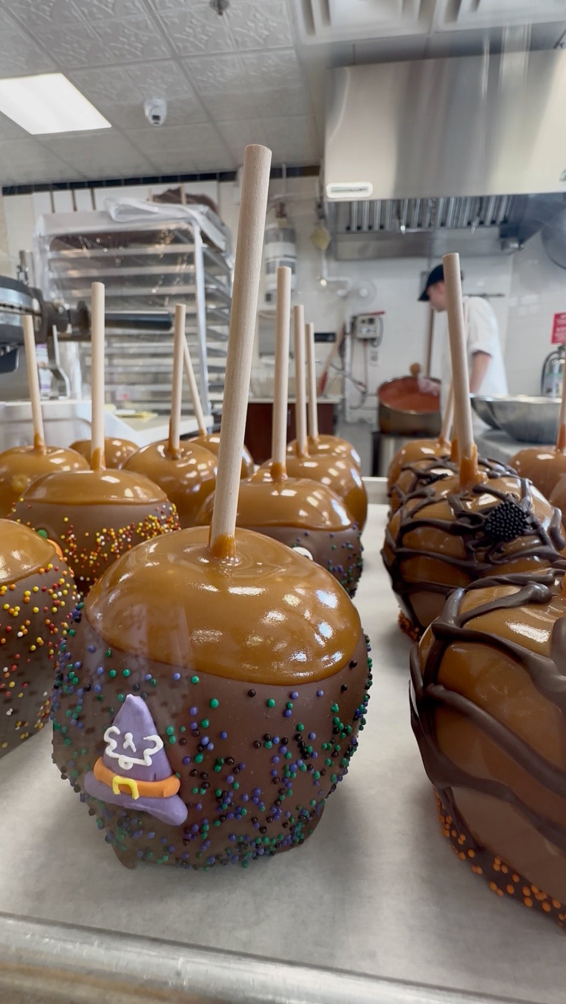 Instagram post by @thegrapevineedit for Kilwins. Caption reads: 🎃🍎 Sweet, spooky, and oh-so-delicious!....