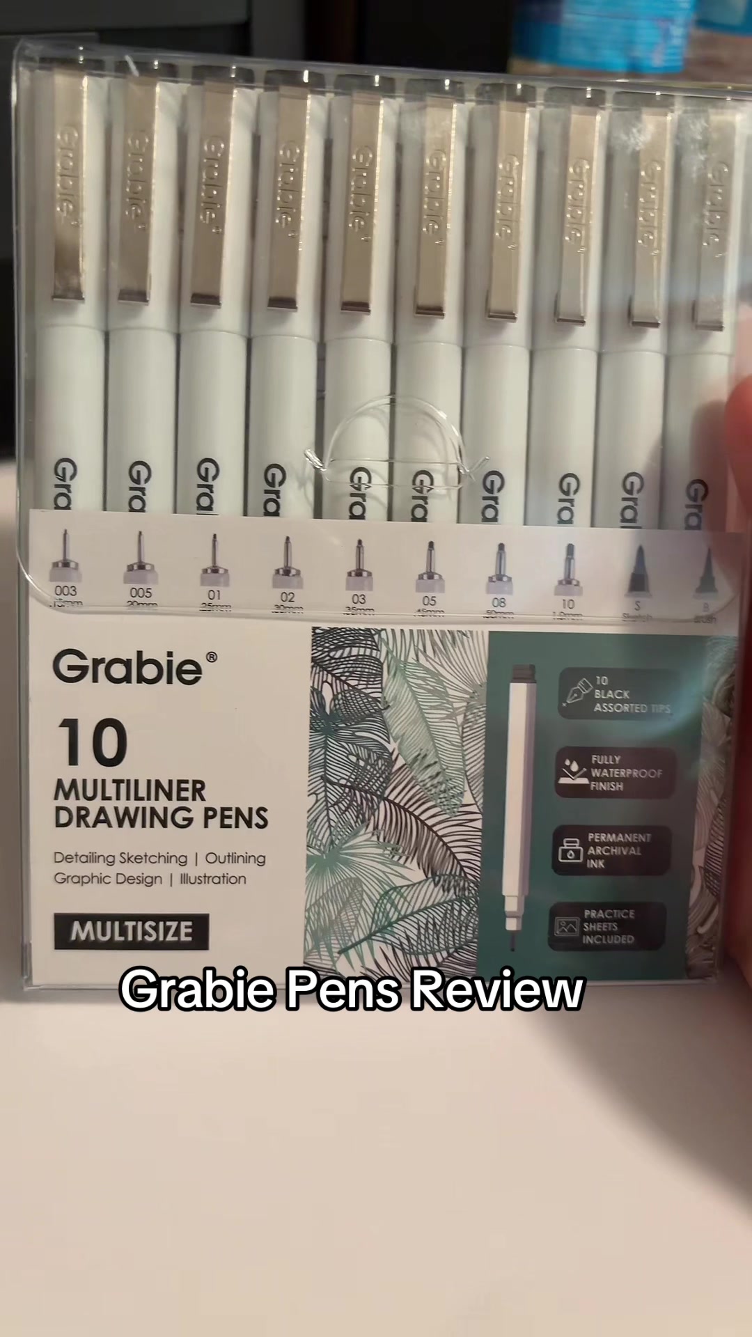 TikTok post by @thefangirl_2025 for Grabie Art. Caption reads: @grabieart amazing pens! Definitely recommend....