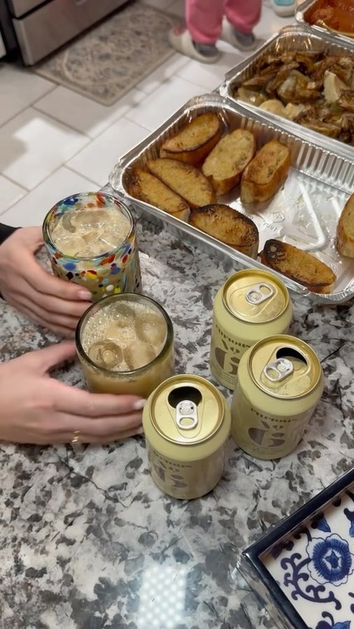 Instagram post by @alcoholfreeindally for curious elixirs. Caption reads: Pizza, pajamas, and @curiouselixirs. Name a better....