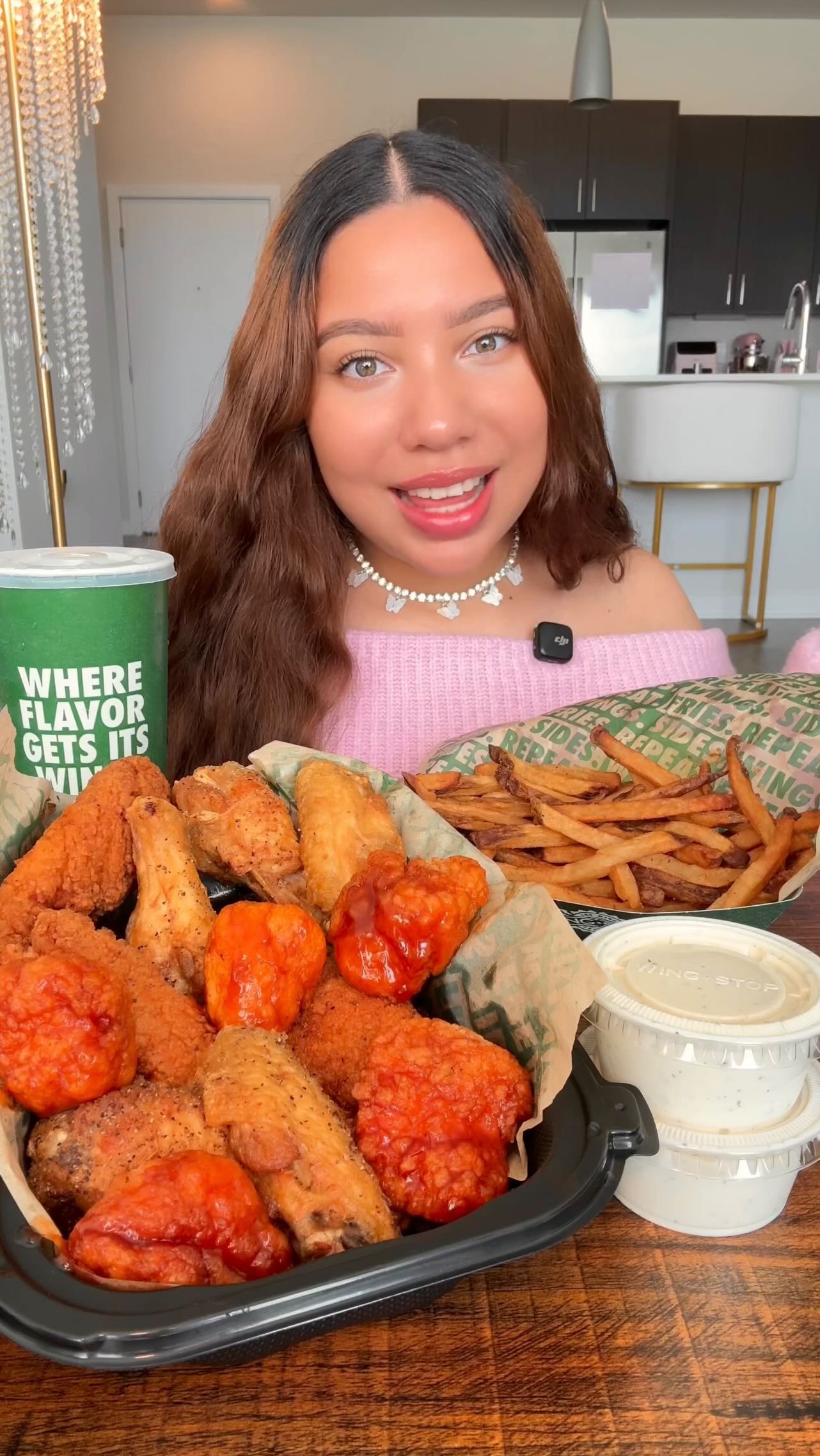 Instagram post by @claudiaeatsgood for Wingstop. Caption reads: album drops at midnight 🎶✨ good thing @wingstop....