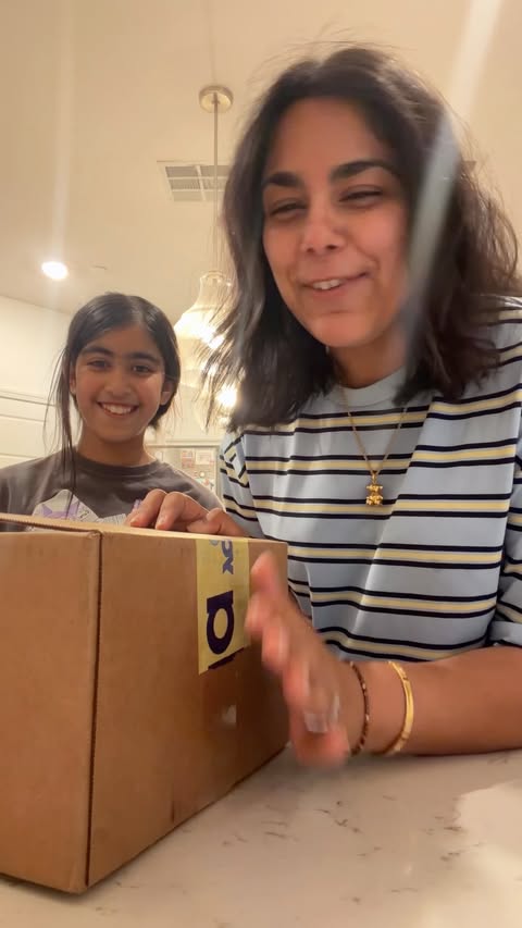 Instagram post by @tushapv for Frida Baby. Caption reads: Two PR packages arrived, and the girls were very....