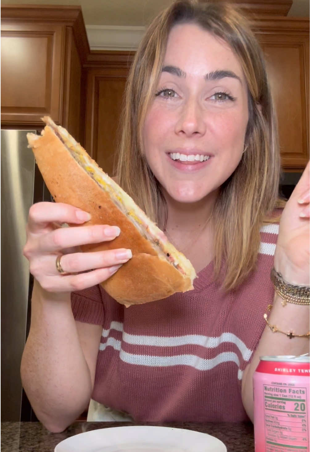 TikTok post by @jennaheats for Bloom Nutrition. Caption reads: Cuban sandwich, chips and a Bloom Pop Shirley....