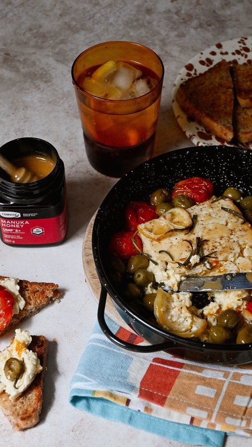 Instagram post by @eleanor.cripps for Comvita. Caption reads: [...] Tender baked feta with beautiful @comvita_nz....