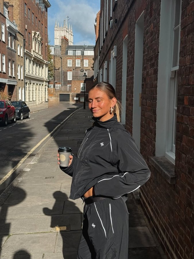 Instagram post by @izzyhillfit for REPRESENT CLO. Caption reads: Picking up my morning coffee in @247represent....