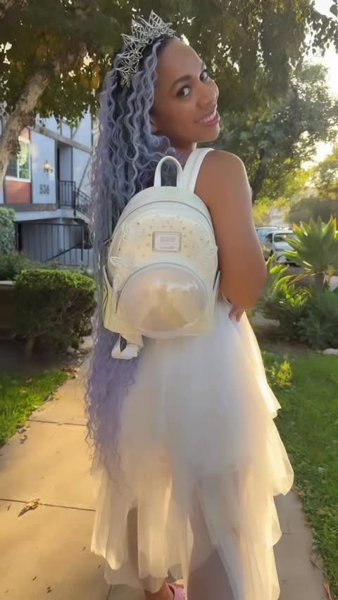 Instagram post by @followtheyellowbrickgirl for loungefly. Caption reads: |Whether you are rocking your inner Glinda or....