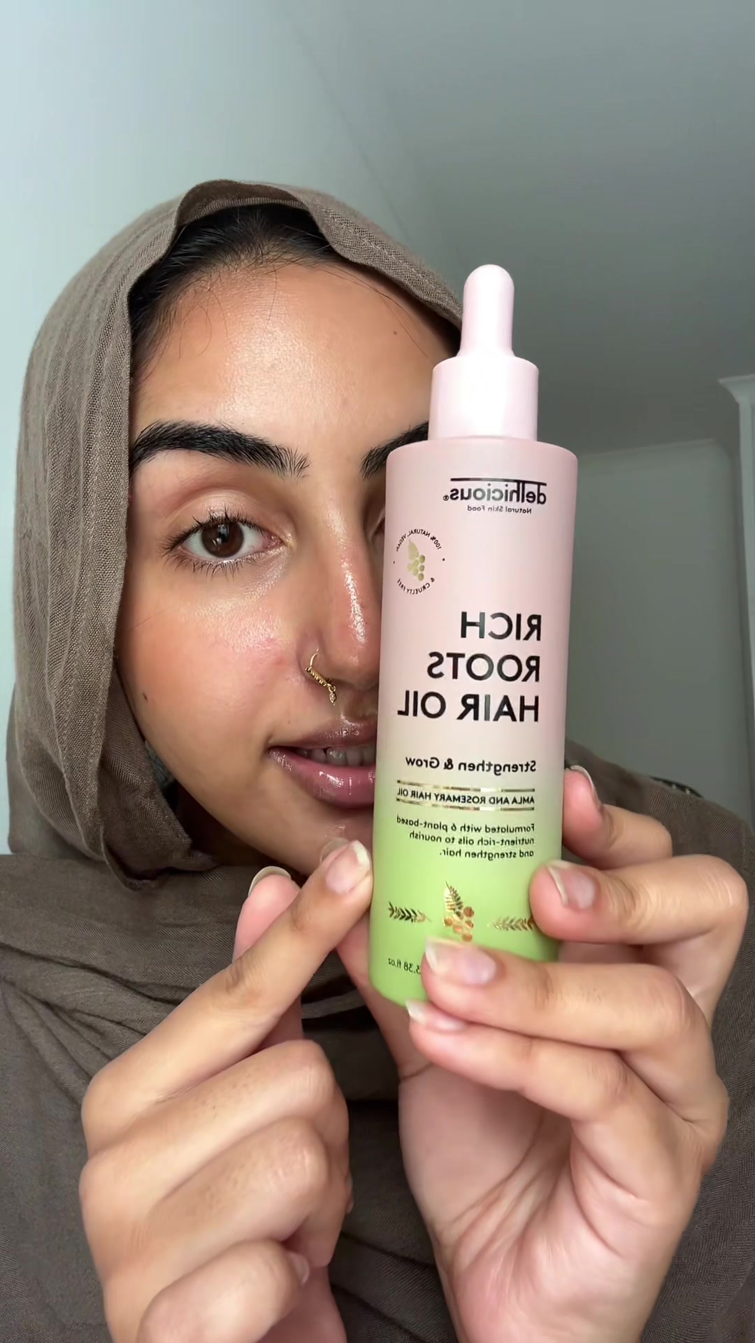 TikTok post by @ugcdiaries for Delhicious Body. Caption reads: This hair oil is a 4 in 1 and you need to try it!....