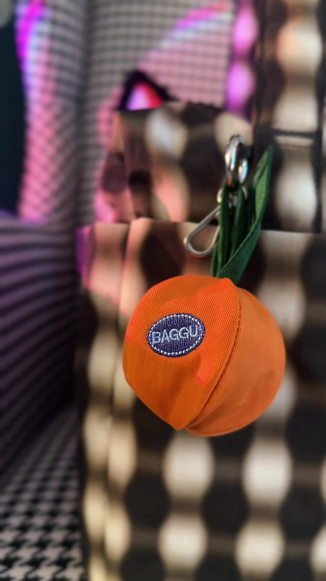TikTok post by @milliewearsit for BAGGU. Caption reads: 🍊 the @BAGGU Mandarin Orange bag charm [...].