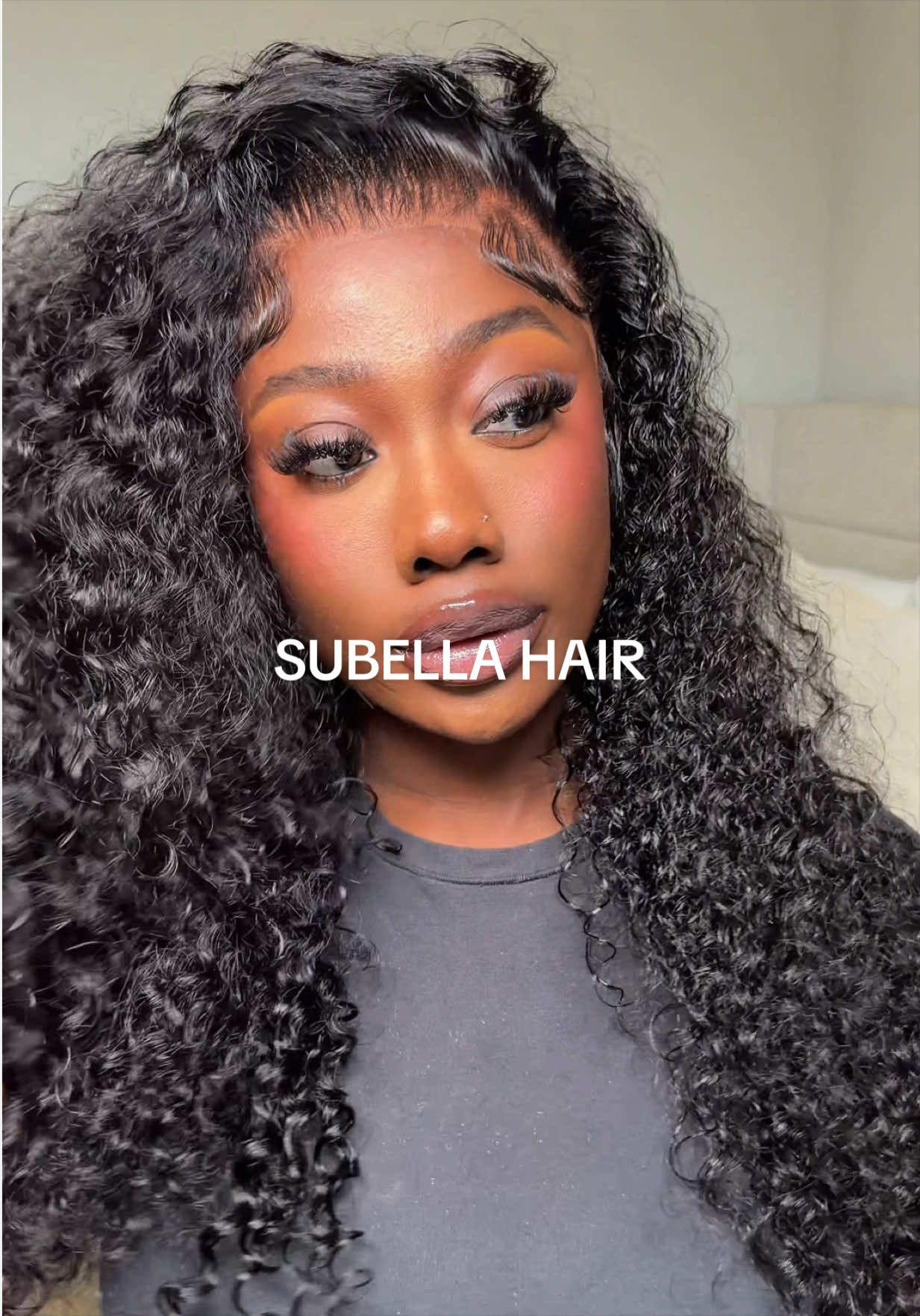 TikTok post by @b0lade for Subella Hair. Caption reads: I’m loving this curly unit 😍😍 @Subella Hair....