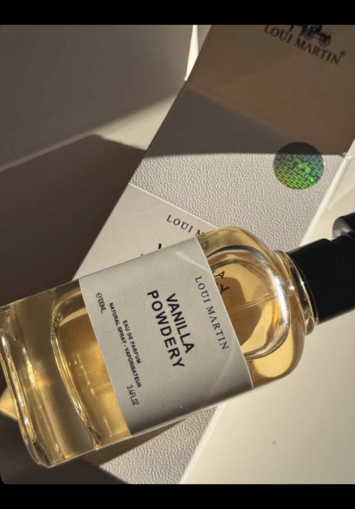 TikTok post by @enalacreates for Aprizo. Caption reads: [...] a warm vanilla hug in a bottle 🤍🕊️....