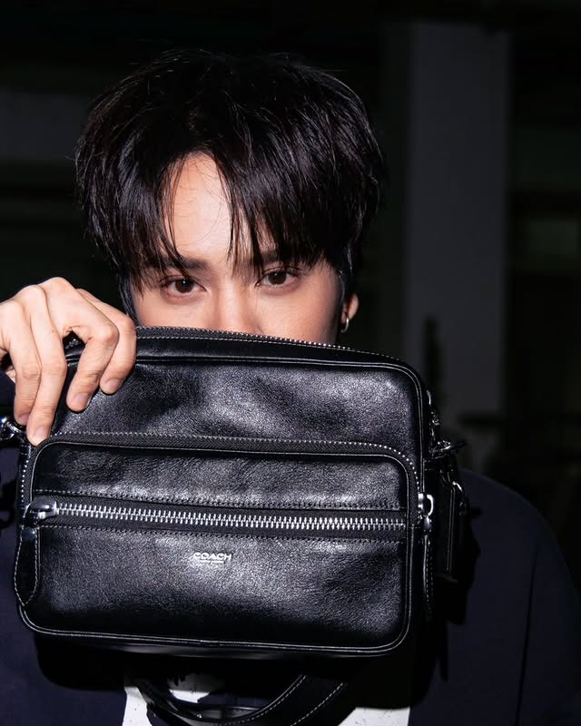 Instagram post by @nanon_korapat for Coach. Caption reads: Caught in the flash. 📸#CoachNY.