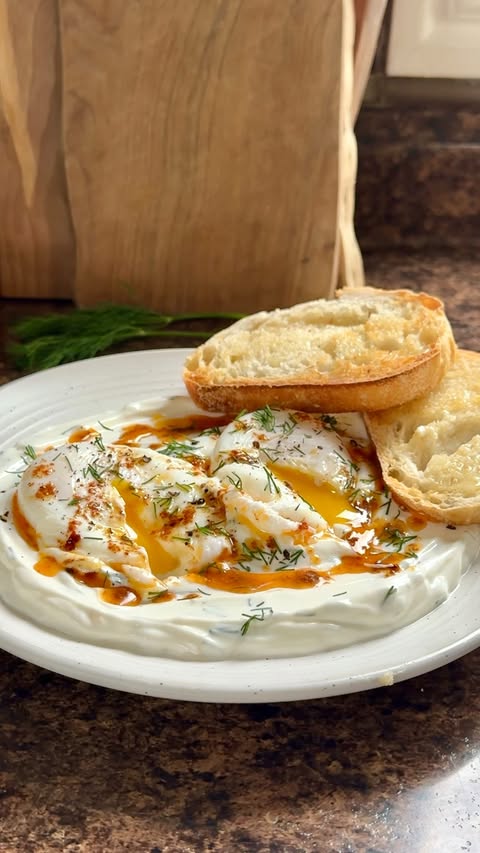 Instagram post by @hannahmagee_rd for Get Cracking. Caption reads: #Ad Making Cilbir (Turkish Eggs) at home 🍳Recipe....