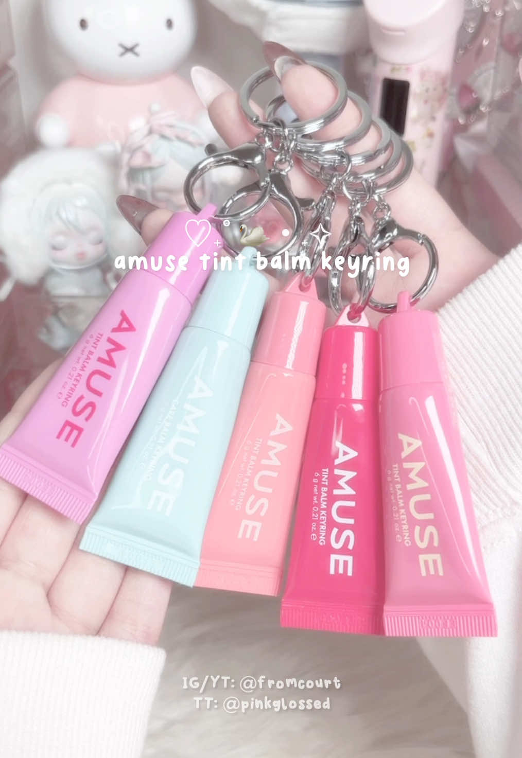 TikTok post by @pinkglossed for AMUSE Seoul. Caption reads: amuse tint balm keyring swatches₊˚ʚ 🌈 ₊˚✧ ﾟ....
