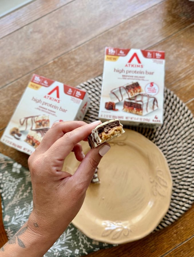 Instagram post by an influencer for Atkins. Caption reads: [...] new layered protein bars from Atkins —....
