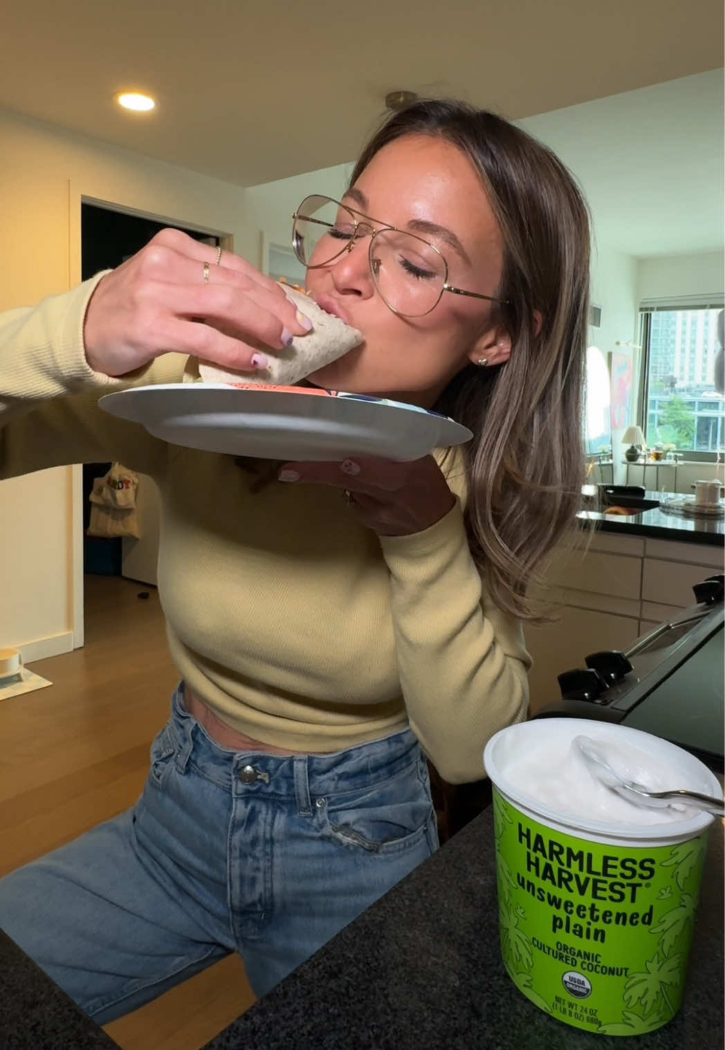 TikTok post by @kbmamaa for Harmless Harvest. Caption reads: What I ate today 🍌🍯🥯☕️🌮✨ @Harmless Harvest....