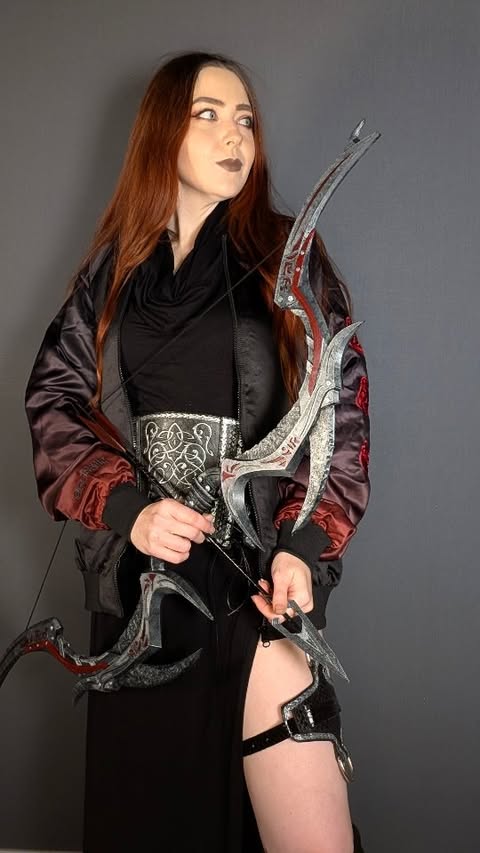 Instagram post by @thescarletthuntress for Blackmilk Clothing. Caption reads: [...] assassins get cold... ⚔️ The new....