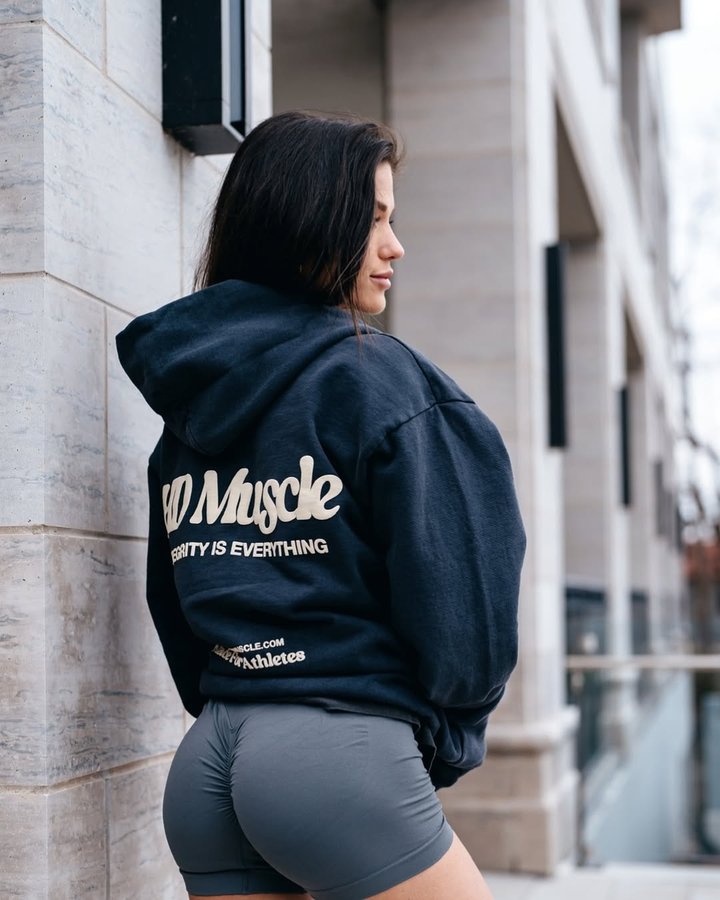 Instagram post by @brittjstone for HD MUSCLE. Caption reads: Complacency kills, never settle, always strive for....