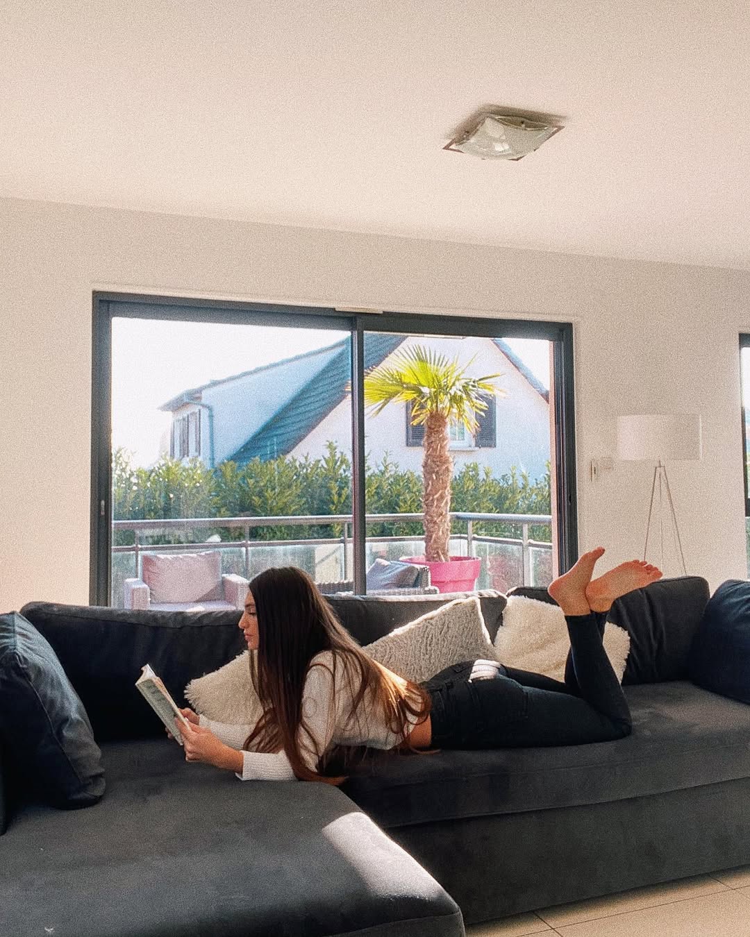 Instagram post by @carlavva for MADE.COM. Caption reads: Enjoying my new appartement🤍 Mon canapé vient de....
