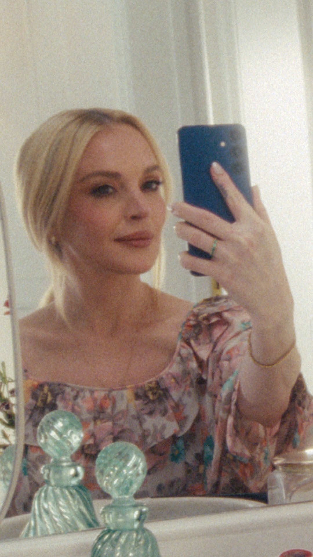 TikTok post by @lindsaylohan for Verizon. Caption reads: My glow-up secret? A free phone from @Verizon.....