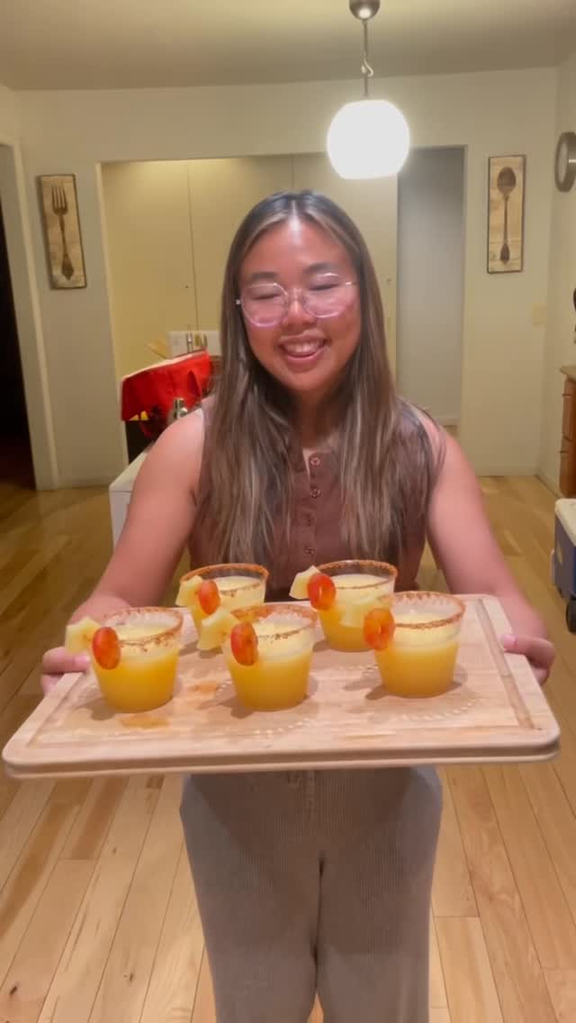 Instagram post by @andrea.eats.food for Snak Club. Caption reads: pineapple frozen margs made with @snakclub peach....