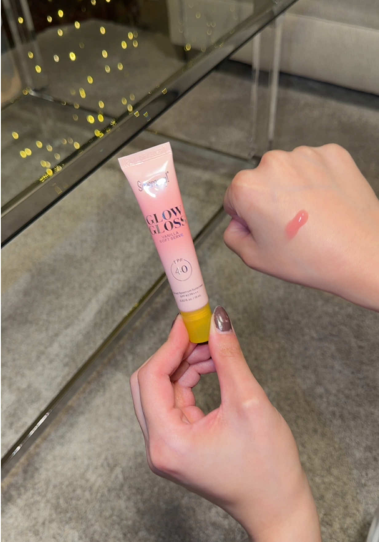 TikTok post by @psychictexas for Supergoop. Caption reads: Absolutely love the @Supergoop spf glow gloss in....