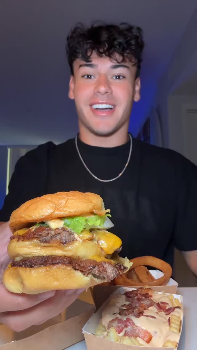 Instagram post by @dylaneatss_ for Shake Shack. Caption reads: Shake Shack’s NEW Big Shack Burger #shakeshack....