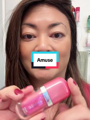 TikTok post by @sharonskincontent for AMUSE Seoul. Caption reads: @AMUSE Seoul Love the glossy shade! #amuseliptint....