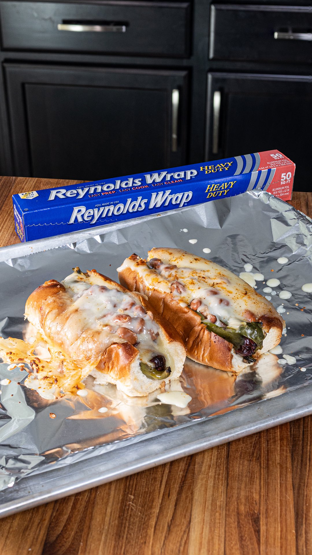 Instagram post by @chilesandsmoke for Reynolds Brands. Caption reads: #ad Sonoran Hot Dogs just got extra cheesy, and....