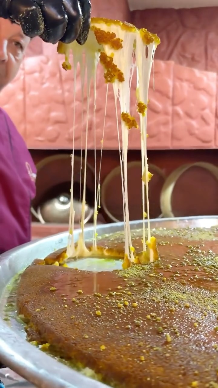 Instagram post by @thecuriouscreature for G Adventures. Caption reads: Will fly for kunafa 😍 He proudly showed me the....