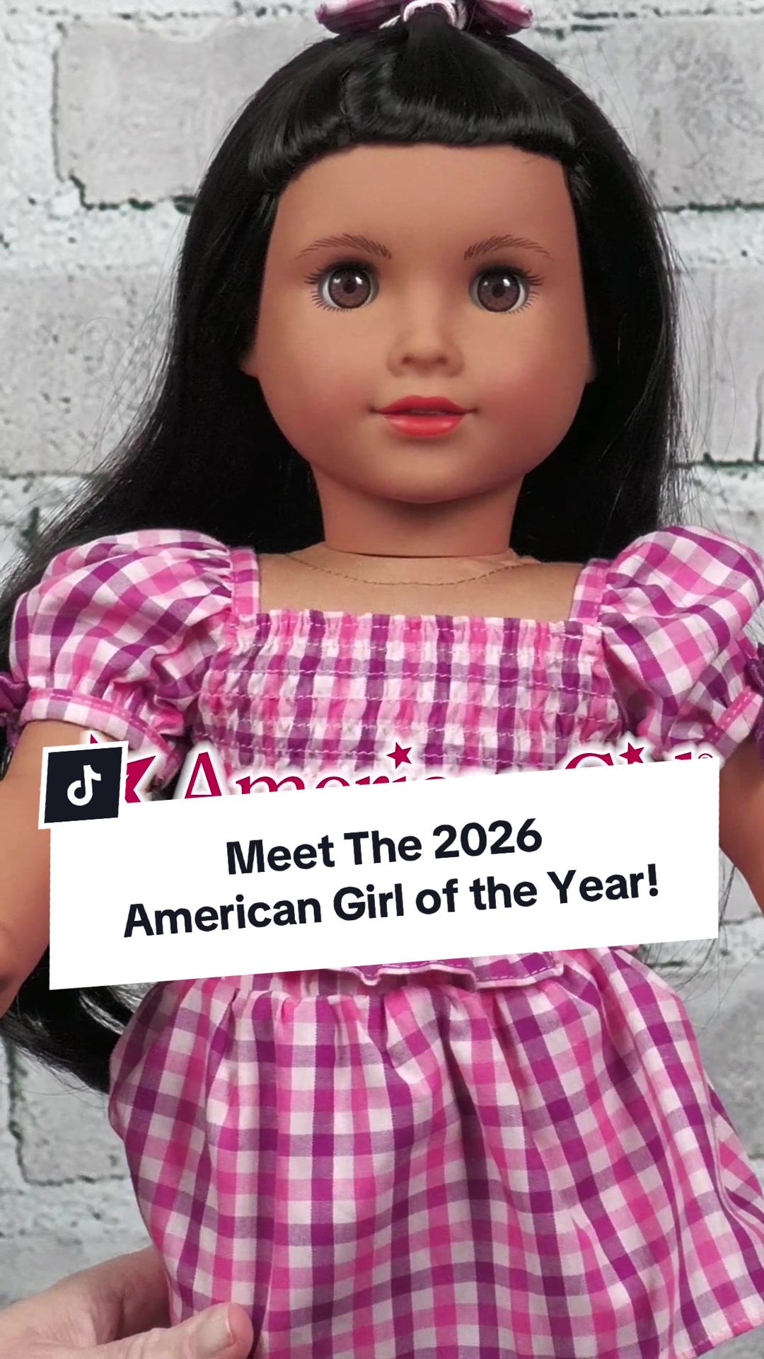TikTok post by @thetoyauthority for American Girl. Caption reads: @American Girl unveils Raquel Reyes, the 2026....