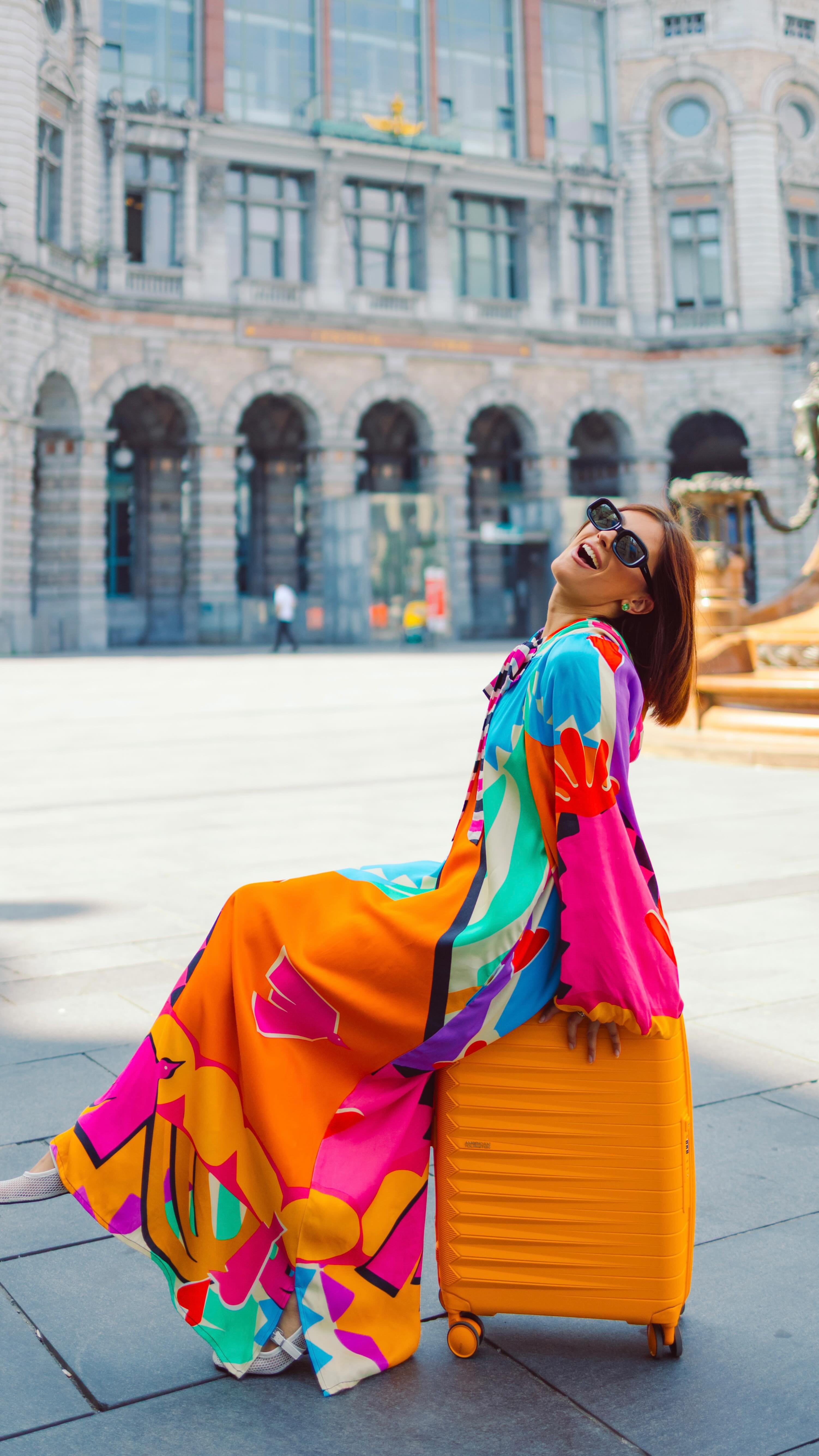 Instagram post by @vlada.cotorobai for American Tourister. Caption reads: Cuteness packed 💛 Luggage matched 🌈 Energy....