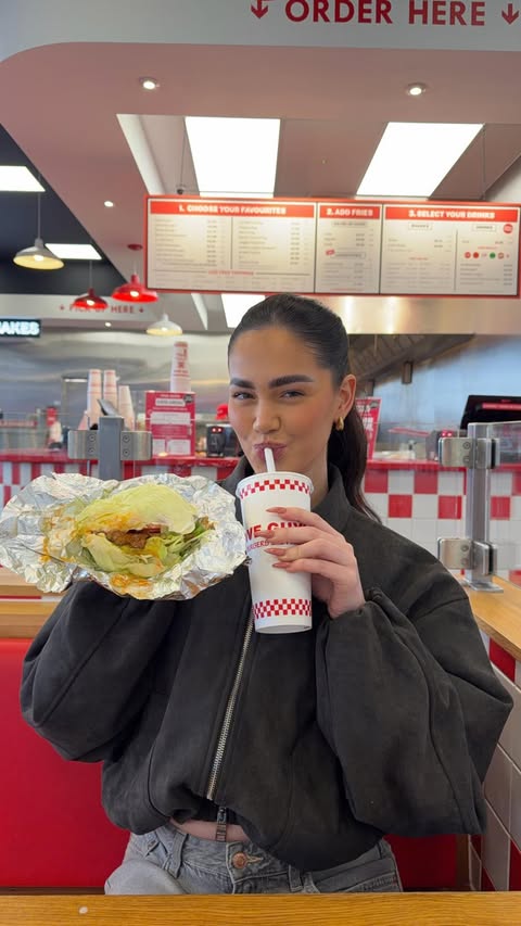 Instagram post by @annamayrobey for Five Guys Burgers & Fries. Caption reads: Trying the VIRAL lettuce wrap & Coca-Cola Zero....