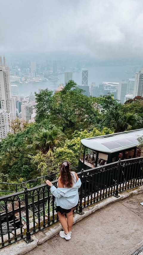 Instagram post by @passportandstamps for Discover Hong Kong. Caption reads: This is your sign to take the Peak Tram in Hong....