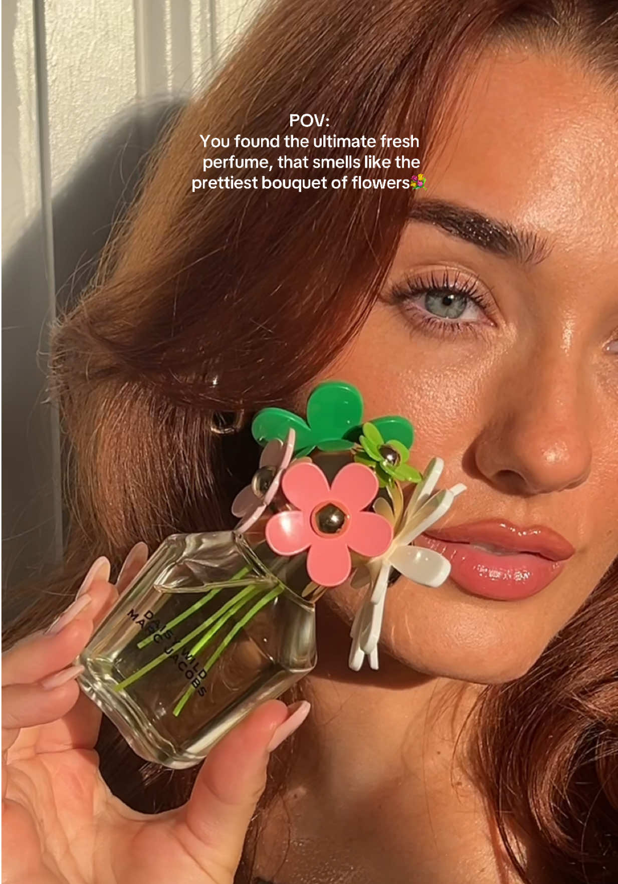 TikTok post by @socialswithclaudia for Marc Jacobs Fragrances. Caption reads: Ad. Daisy Wild makes me want to run through a....