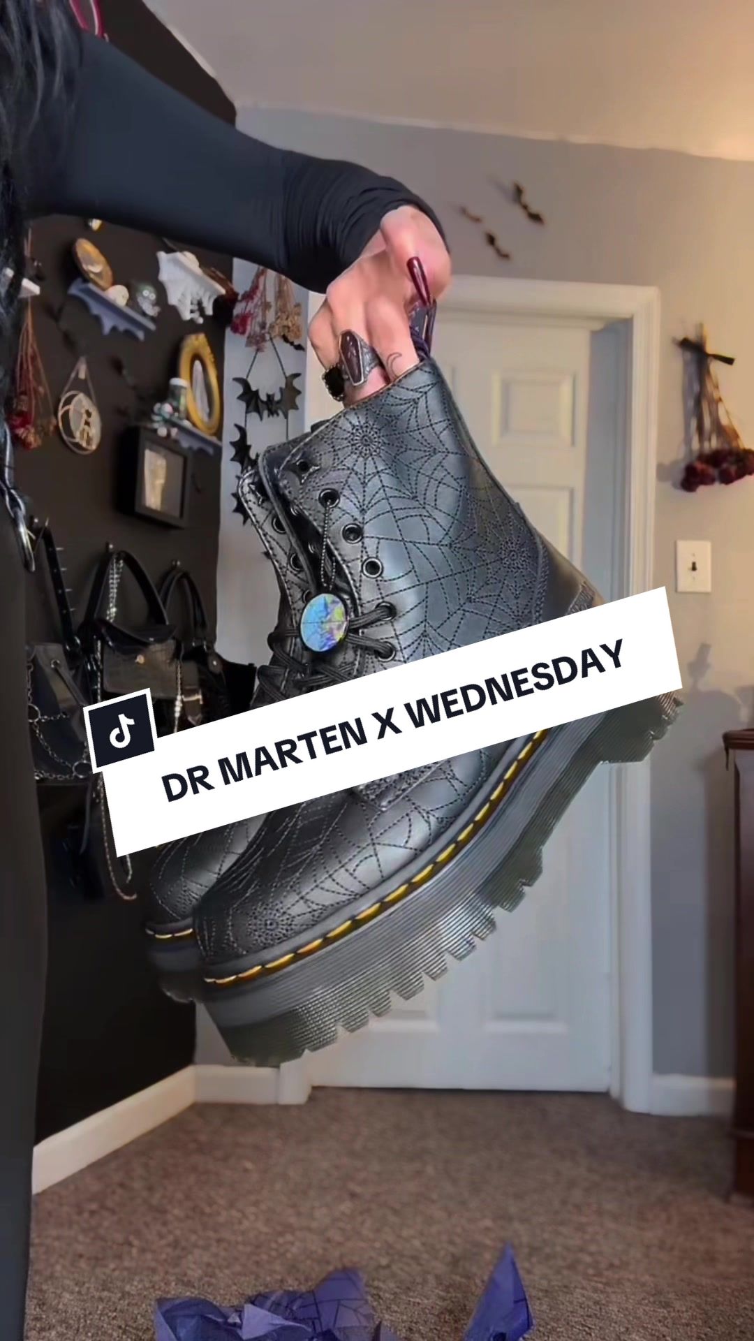 TikTok post by @mariahkrx for Dr Martens. Caption reads: These @Dr. Martens x Wednesday boots are a spooky....