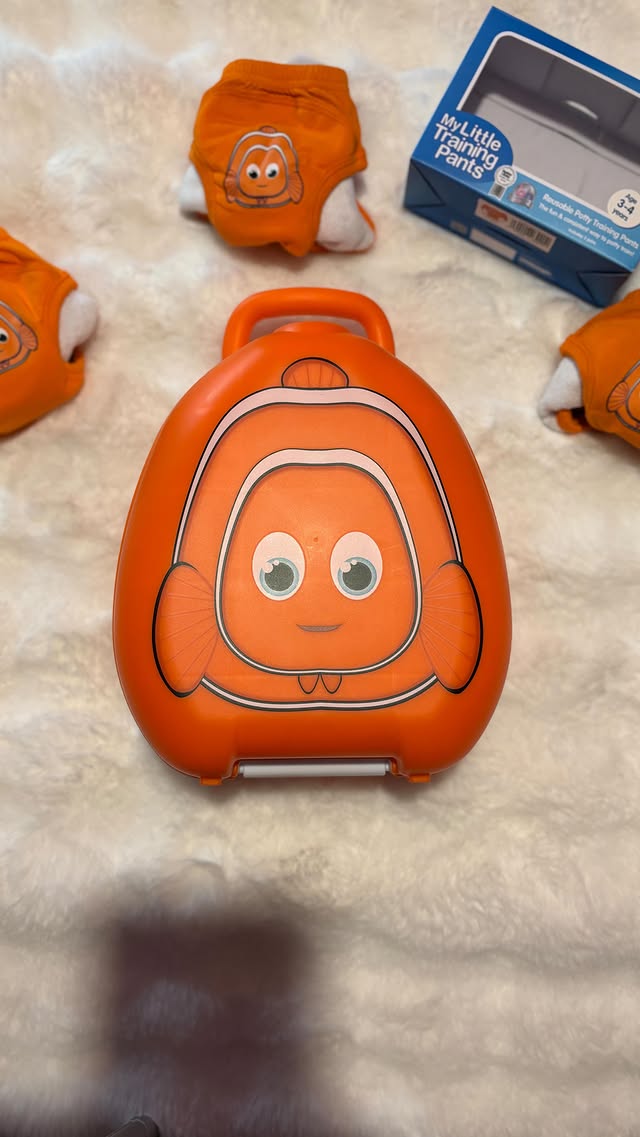 Instagram post by @aggielang for My Carry Potty. Caption reads: AD| @mycarrypotty Clownfish My Carry Potty® &....