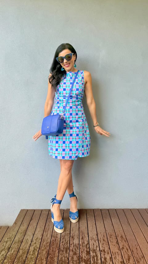 Instagram post by @dreams.of.colour for Pom Pom London. Caption reads: Bringing you the cutest check dress styled with....